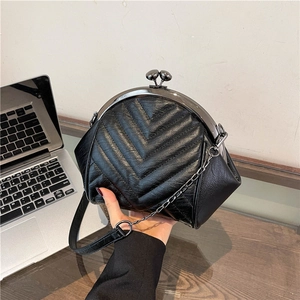 Elegant black quilted underarm bag with gold frame clasp and chain strap for women