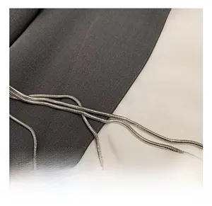 Close-up of a silver metal snake chain strap with fine polishing for a mini evening bag