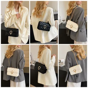 Detail view of quilted chain bag in black and white styles worn with business casual suits
