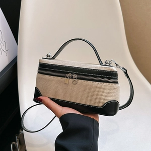 Mini canvas and black leather handbag with contrast stitching and adjustable strap