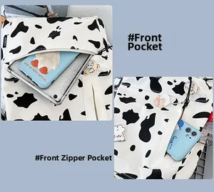 Détail du sac en toile motif vache avec poche zippée avant et rangement pour tablette