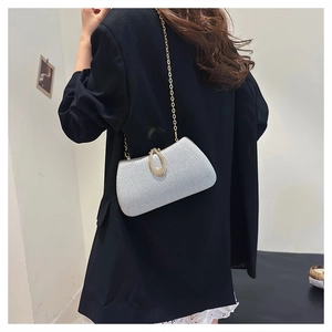Sparkling silver evening bag with gold chain strap and rhinestone horseshoe clasp decoration