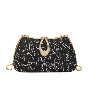 Vintage evening clutch with star-patterned texture and crystal teardrop clasp