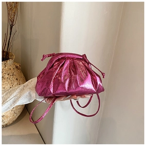 Close-up of metallic magenta ruched cloud bag with matching thin shoulder strap