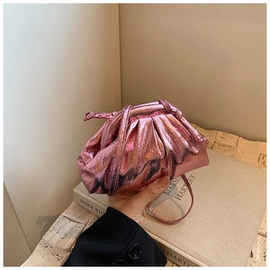 Detail of metallic pink pleated cloud bag with soft textured finish and slim strap