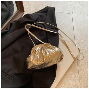 Detail of gold metallic pleated cloud bag with vintage clasp and slim chain strap