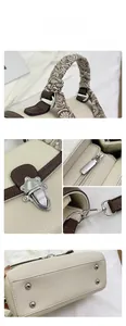 Close-up of litchi texture leather, patterned silk scarf handle and silver hardware