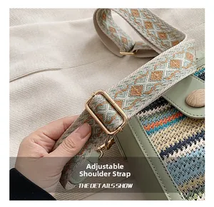 Close-up of the adjustable jacquard shoulder strap and gold metal buckle on a woven bag