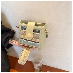 Detail of colorful woven crossbody bag with geometric jacquard strap and wooden buckle