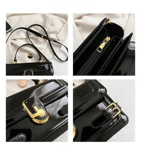 Détails du cuir verni noir brillant avec ferrures dorées et fermeture à glissière chic