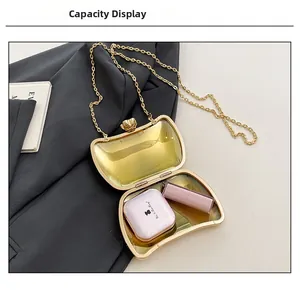 Internal view of the gold irregular shell clutch bag showing lipstick and cushion capacity