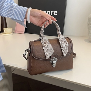 Brown litchi grain handbag with paisley scarf and silver clasp for elegant styling