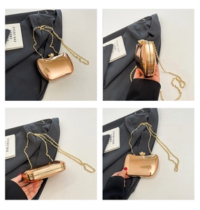 Detail view of rose gold metallic clutch bag showing hard shell and gold chain strap