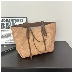 Dettaglio della borsa tote grande con texture a serpente e manici marroni a contrasto