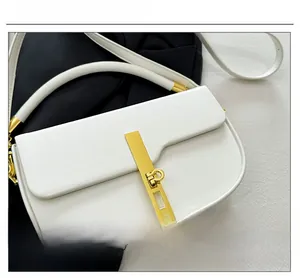 Detail of white saddle bag showing high-quality gold metal buckle and smooth leather