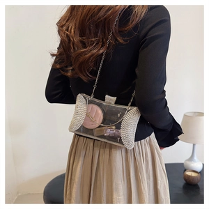Elegant transparent acrylic evening clutch bag with sparkling rhinestone edges and chain