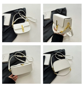 Detail view of white saddle bag showing gold hardware buckle and textured faux leather