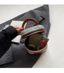 Internal view of mini woven cylindrical bag showing capacity for wallet and accessories