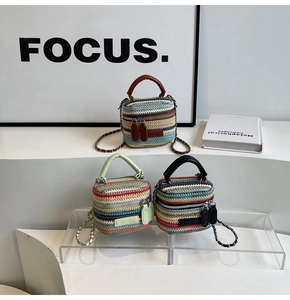 Detailed view of mini woven rainbow bucket bags with leather handles and chain straps