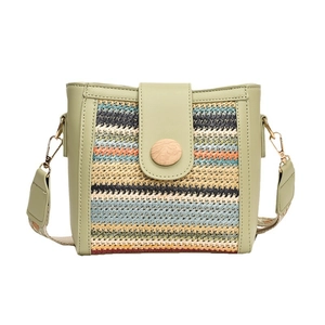 Minimalist straw patchwork shoulder bag with wide ethnic strap and green leather trim