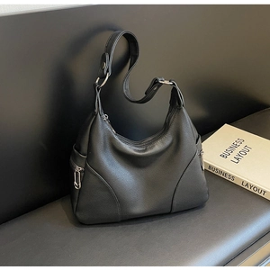 Close-up of black litchi grain leather hobo bag with adjustable strap and side silver zipper