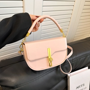 Pink faux leather saddle bag with gold metal clasp and adjustable shoulder strap