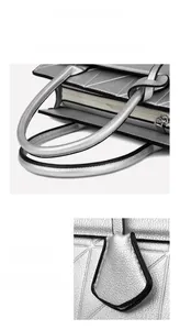 Macro detail of ergonomic thick handles and silver quilted texture on a large tote bag