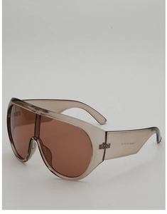 Detail of wide temple hinge and inner serial number on brown oversized shield sunglasses