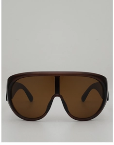 Detail of oversized one-piece tortoiseshell sunglasses with brown UV protection lenses