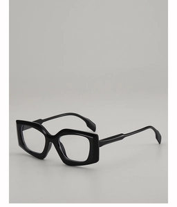 Detail shot of black hexagonal glasses frames with high-gloss finish and clear lenses