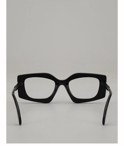Close-up of black irregular rectangular thick frame glasses with glossy finish