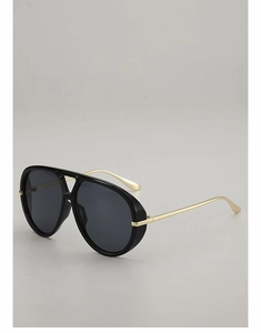 Detail of pilot sunglasses showing black frame, gray lenses and thin gold metal temples