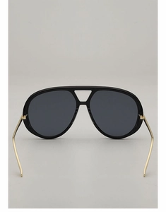 Detail view of large aviator sunglasses with gold metal temples and black top bar