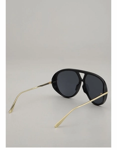 Detail view of large aviator sunglasses with black frames and slim gold metal temples