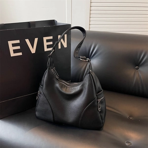 Minimalist black pebble leather hobo bag with side zippers and spacious design