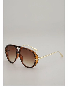Detail of tortoise frame and gold metal temples on vintage pilot sunglasses