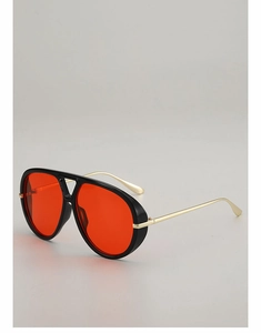Detail view of red pilot sunglasses with black frames and slim gold metal temples