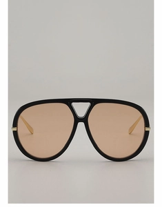 Detailed view of black aviator sunglasses with amber lenses and gold metal hinges
