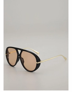 Close-up of vintage aviator sunglasses featuring black frames and gold metal temples