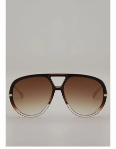 Close-up of brown gradient pilot sunglasses with gold metal accents and hollow bridge
