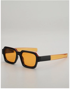 Detail of square sunglasses featuring black frames and vibrant orange tinted lenses