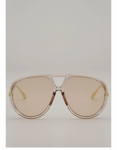 Detail view of large aviator sunglasses with champagne frames and brown lenses