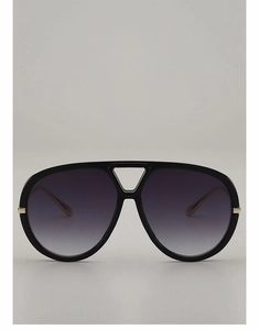 Detail of aviator sunglasses featuring black frames with elegant gold hinge accents