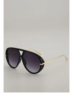 Detail of pilot sunglasses with thick black frames, gold temples and gradient lenses