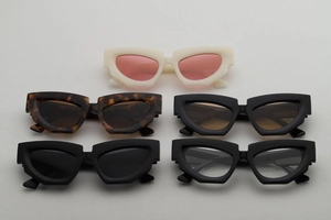 Flat lay view showing five colors of chunky cat eye sunglasses with thick angular frames