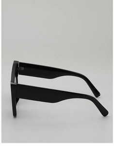Side view of chunky black cat-eye sunglasses with wide temples and high-gloss finish
