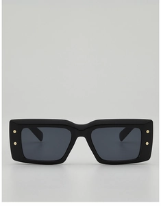 Détail de lunettes de soleil rectangulaires noires brillantes avec rivets dorés