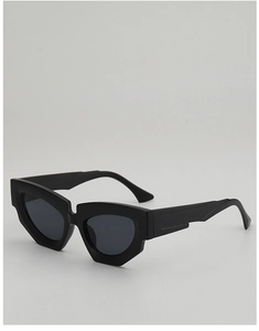 Detail shot of black irregular geometric sunglasses with thick frames and dark lenses