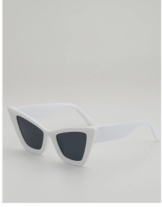 Detailed side view of vintage white cat-eye sunglasses with dark grey lenses