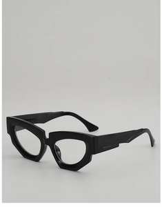 Detail of glossy black irregular cat eye sunglasses with thick geometric frames